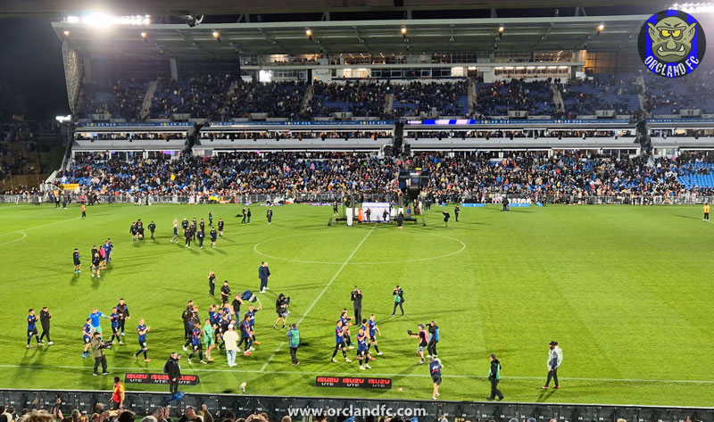 Auckland FC players celebrating the Premiers' Plate with fans in the stands- A-League Season 24/25