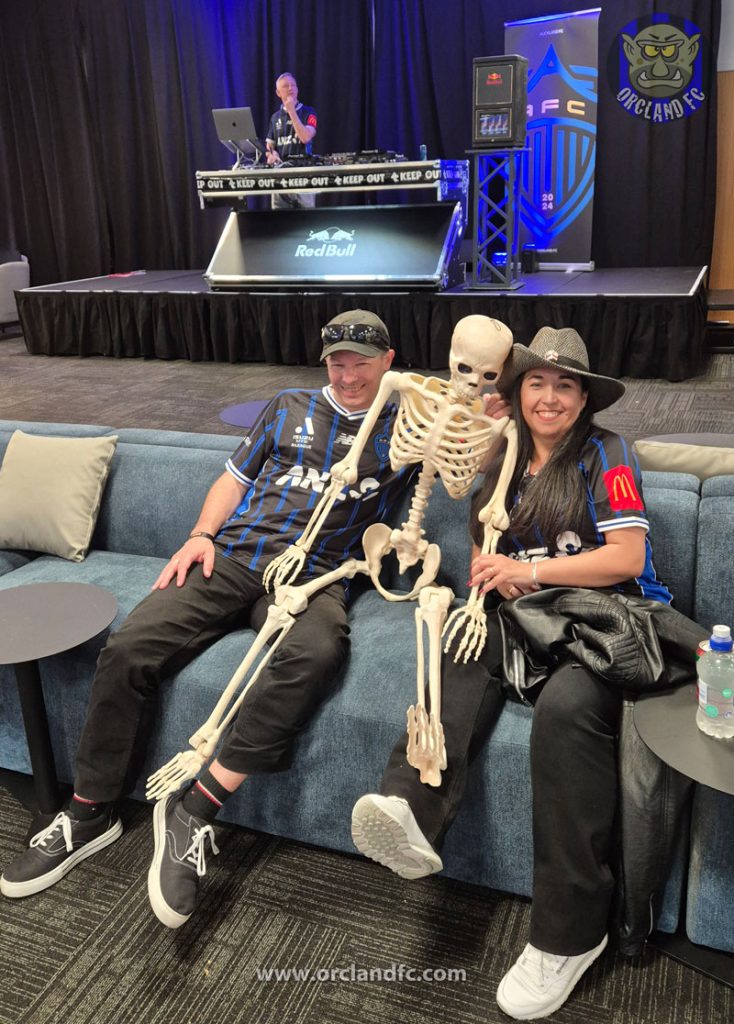 Rob and Ange (Orcland FC) with a skeleton at the Auckland FC Black Knight Club (with a DJ in the background)