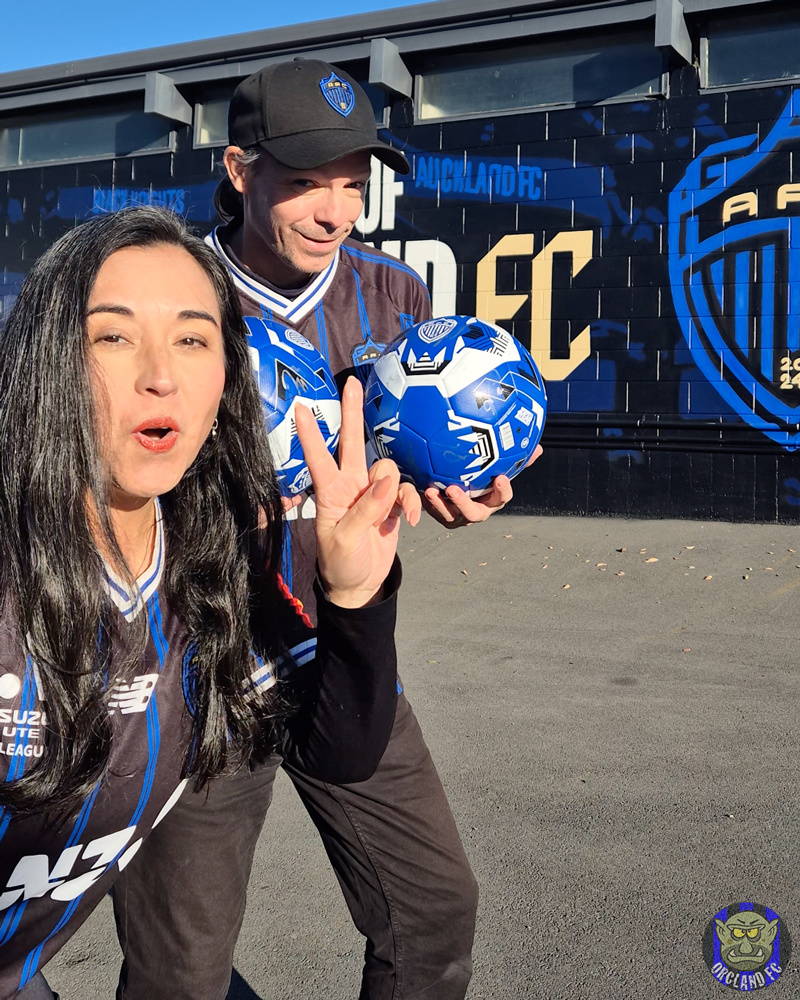 Rob and Ange from Orcland FC at Mount Smart Stadium with two signed Auckland FC Footballs to giveaway.